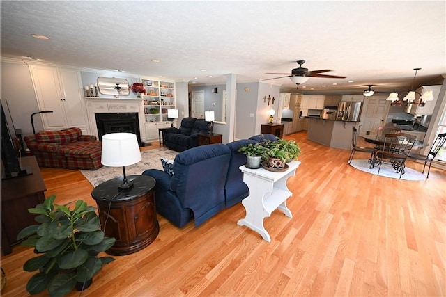 1765 Creekwood Trl, Auburn, AL 36830 - living area with light wood-style floors, ceiling fan, a fireplace, and recessed lighting