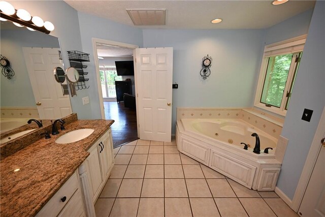 1765 Creekwood Trl, Auburn, AL 36830 - full bath featuring a jetted tub, vanity, tile patterned floors, and recessed lighting