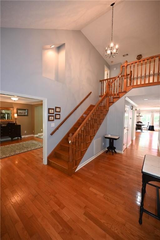 1765 Creekwood Trl, Auburn, AL 36830 - stairway with high vaulted ceiling, wood finished floors, and a chandelier