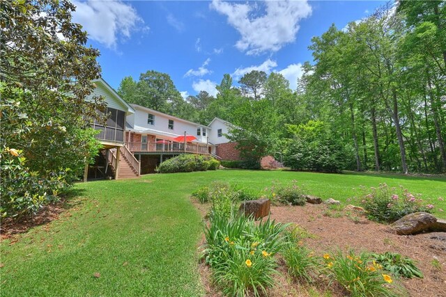 1765 Creekwood Trl, Auburn, AL 36830 - view of grassy yard featuring stairs, a sunroom, and a deck