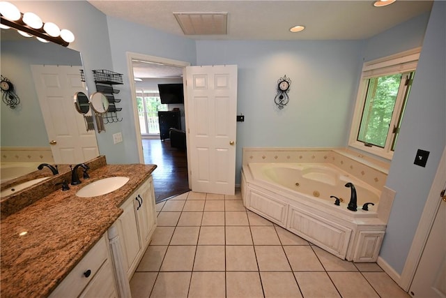 1765 Creekwood Trl, Auburn, AL 36830 - bathroom featuring a jetted tub, vanity, and tile patterned flooring