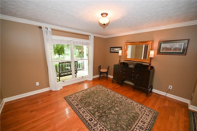 1765 Creekwood Trl, Auburn, AL 36830 - living area with wood finished floors, crown molding, and a textured ceiling