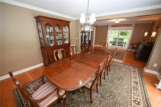 1765 Creekwood Trl, Auburn, AL 36830 - dining room featuring a chandelier, wood finished floors, and ornamental molding