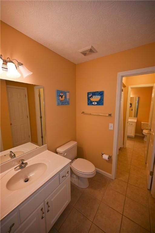 1765 Creekwood Trl, Auburn, AL 36830 - bathroom featuring tile patterned flooring, vanity, and a textured ceiling