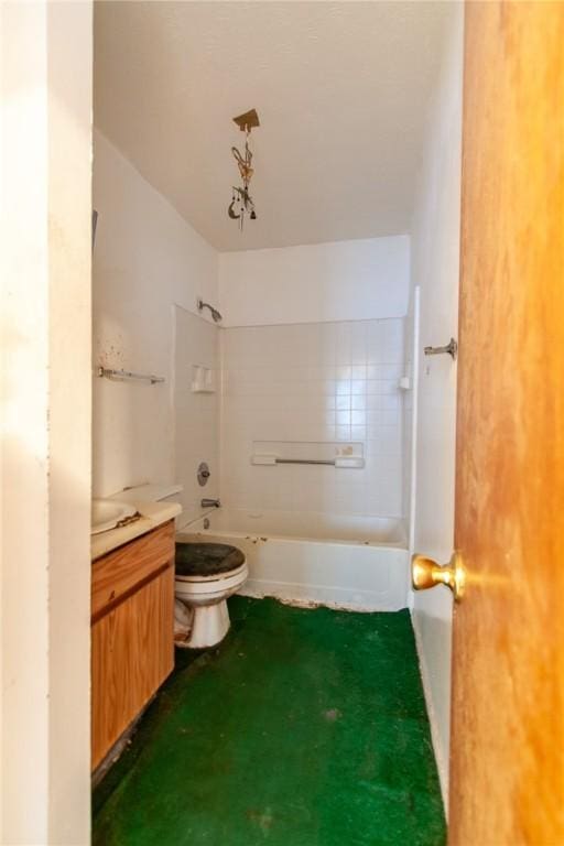 full bathroom featuring tiled shower / bath, vanity, and toilet