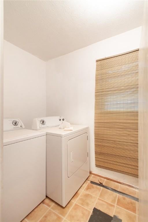 clothes washing area with tile patterned flooring and independent washer and dryer