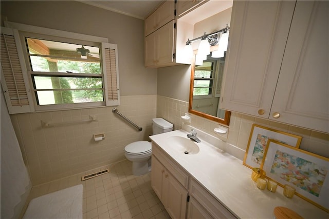 510 S Dean Rd, Auburn, AL 36830 - bathroom with tile patterned floors, vanity, tile walls, and wainscoting