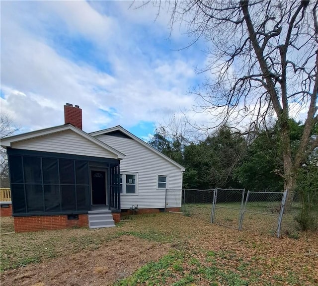 rear view of property with a sunroom