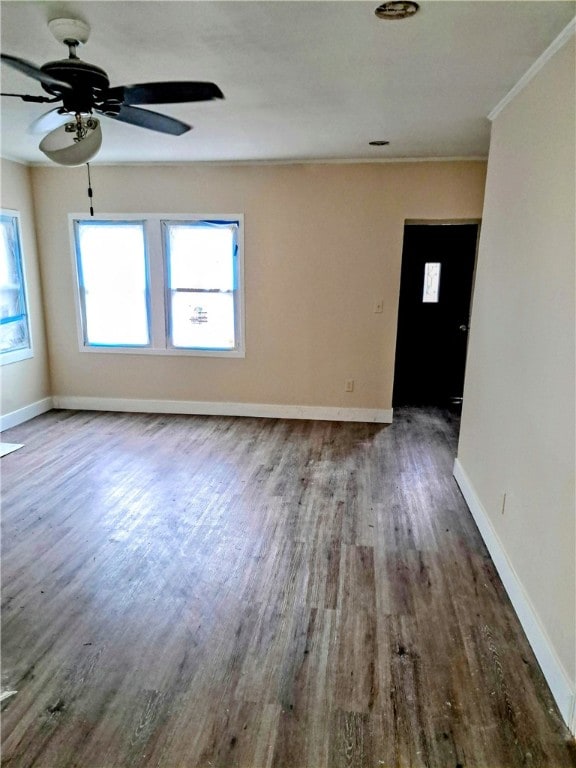 empty room featuring ceiling fan, ornamental molding, and hardwood / wood-style floors