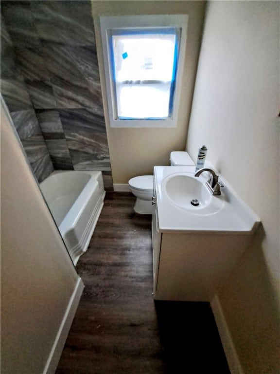 bathroom featuring vanity, hardwood / wood-style floors, and toilet