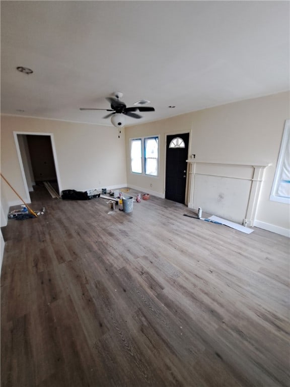 unfurnished living room featuring ceiling fan and hardwood / wood-style floors