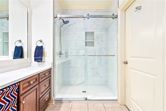 bathroom with ornamental molding, vanity, and a marble finish shower