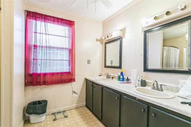 bathroom featuring ceiling fan, ornamental molding, and vanity