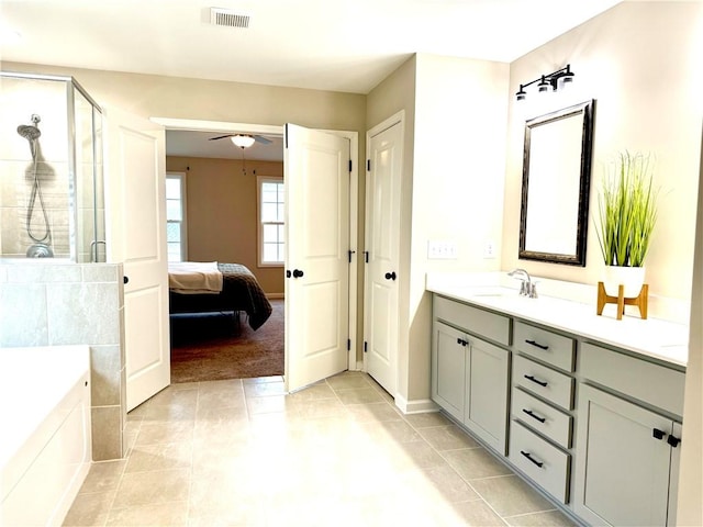 bathroom with tile patterned flooring, vanity, visible vents, a ceiling fan, and a shower stall