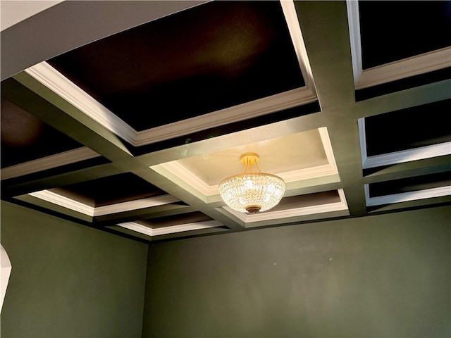 details with a chandelier, beamed ceiling, coffered ceiling, and crown molding