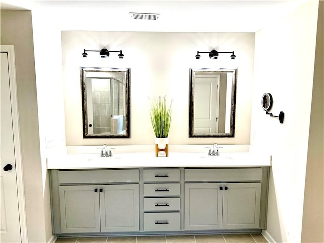 full bath with visible vents, a sink, and double vanity