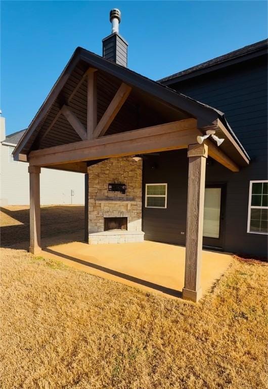 view of patio with a fireplace