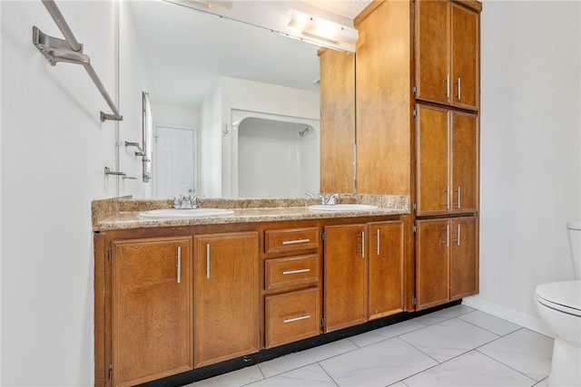 bathroom featuring tile patterned flooring, vanity, and toilet