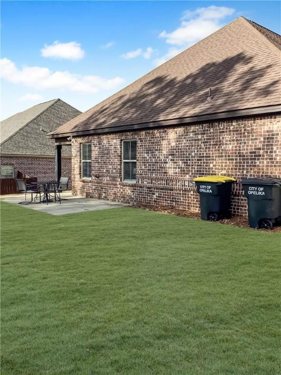 518 High Dr, Opelika, AL 36804 - back of house featuring brick siding, a shingled roof, and a lawn