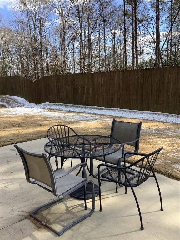 view of patio with fence and outdoor dining space