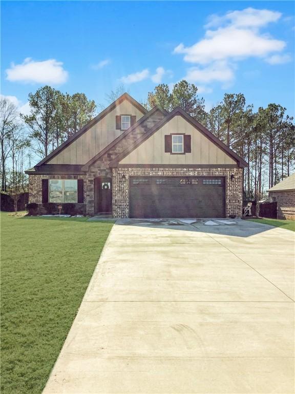 518 High Dr, Opelika, AL 36804 - view of front of house featuring concrete driveway, a front yard, an attached garage, brick siding, and board and batten siding