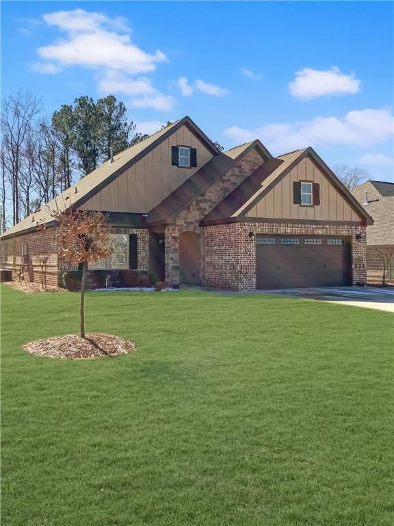 518 High Dr, Opelika, AL 36804 - view of front of property featuring board and batten siding, a front lawn, driveway, and brick siding