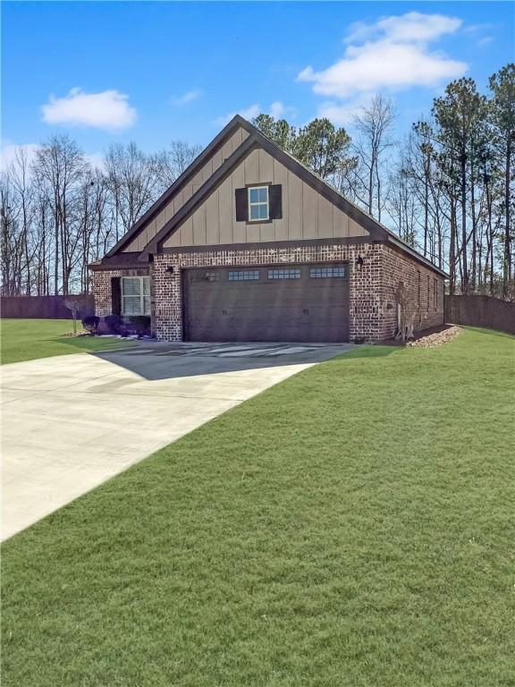 518 High Dr, Opelika, AL 36804 - view of front of property featuring brick siding, concrete driveway, a garage, board and batten siding, and a front lawn