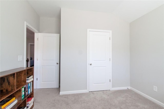 2647 Dunkirk Cir, Auburn, AL 36832 - unfurnished bedroom featuring light carpet, lofted ceiling, and baseboards