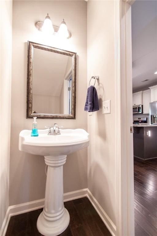 2647 Dunkirk Cir, Auburn, AL 36832 - bathroom featuring baseboards and wood finished floors