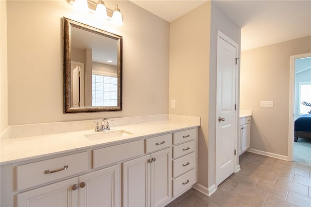 2647 Dunkirk Cir, Auburn, AL 36832 - ensuite bathroom featuring vanity, plenty of natural light, and baseboards