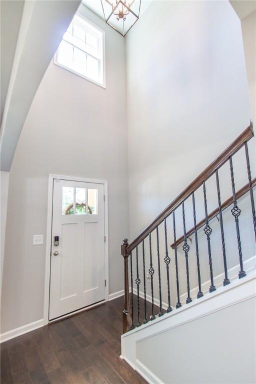 2647 Dunkirk Cir, Auburn, AL 36832 - entryway with arched walkways, wood finished floors, plenty of natural light, stairs, and a towering ceiling