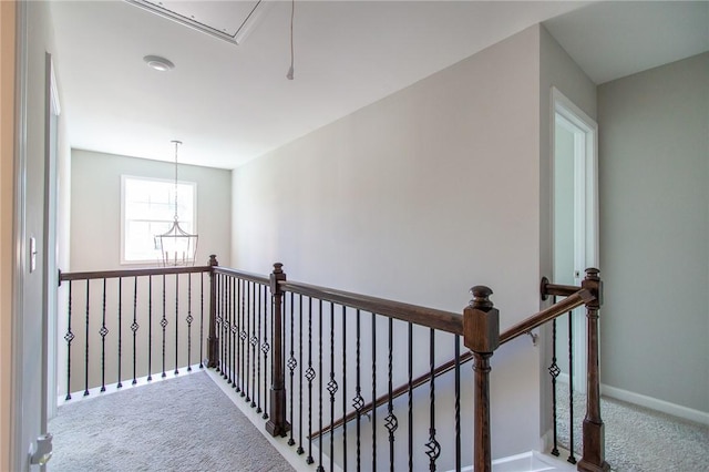 2647 Dunkirk Cir, Auburn, AL 36832 - hallway with carpet, an upstairs landing, attic access, a chandelier, and baseboards