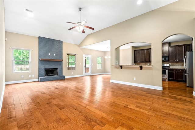 2316 Tuscany Pl, Auburn, AL 36830 - unfurnished living room featuring a wealth of natural light, a ceiling fan, light wood-style floors, and a fireplace