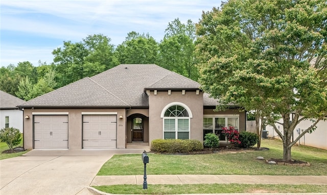 2316 Tuscany Pl, Auburn, AL 36830 - view of front of house with driveway, a shingled roof, an attached garage, a front yard, and stucco siding