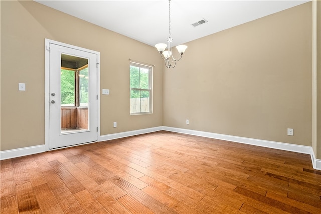 2316 Tuscany Pl, Auburn, AL 36830 - unfurnished room with baseboards, hardwood / wood-style flooring, visible vents, and an inviting chandelier
