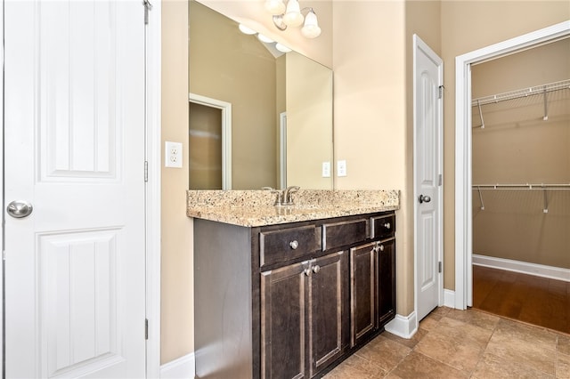 2316 Tuscany Pl, Auburn, AL 36830 - bathroom with baseboards, vanity, and a walk in closet
