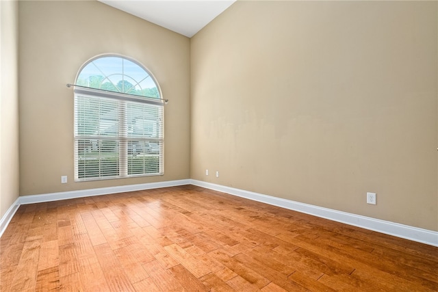 2316 Tuscany Pl, Auburn, AL 36830 - spare room featuring light wood-type flooring, lofted ceiling, and baseboards