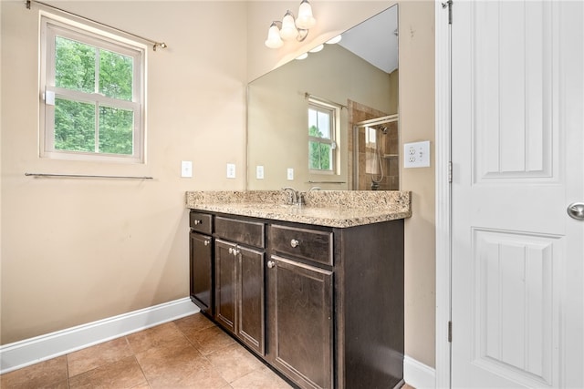 2316 Tuscany Pl, Auburn, AL 36830 - bathroom with vanity, baseboards, a healthy amount of sunlight, and a stall shower