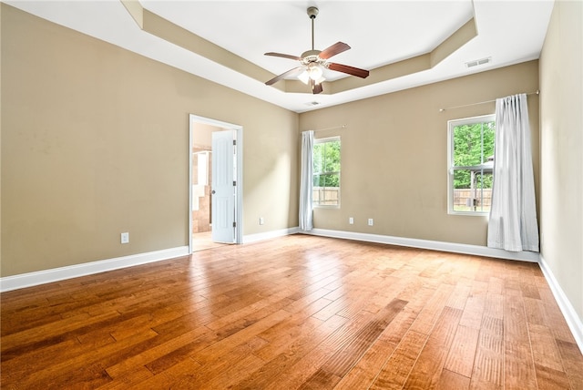 2316 Tuscany Pl, Auburn, AL 36830 - unfurnished room with a ceiling fan, a tray ceiling, light wood finished floors, and plenty of natural light