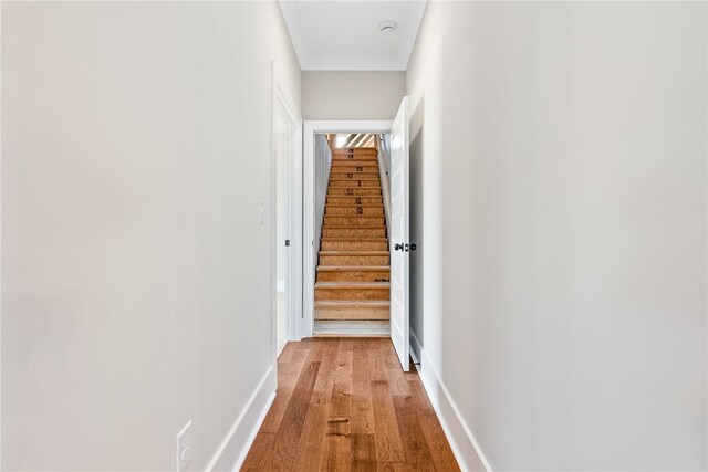 hallway with light wood-style flooring and baseboards