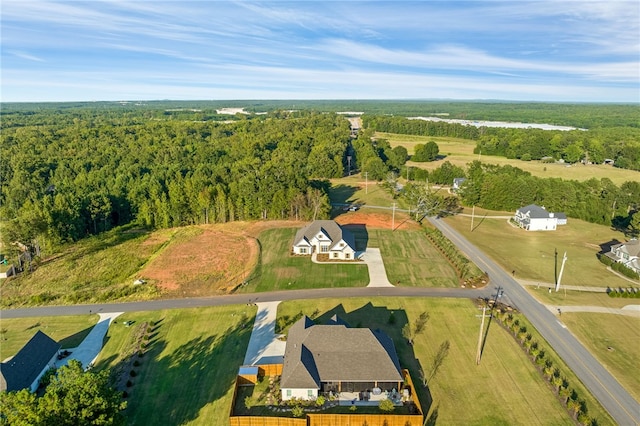 drone / aerial view featuring a wooded view