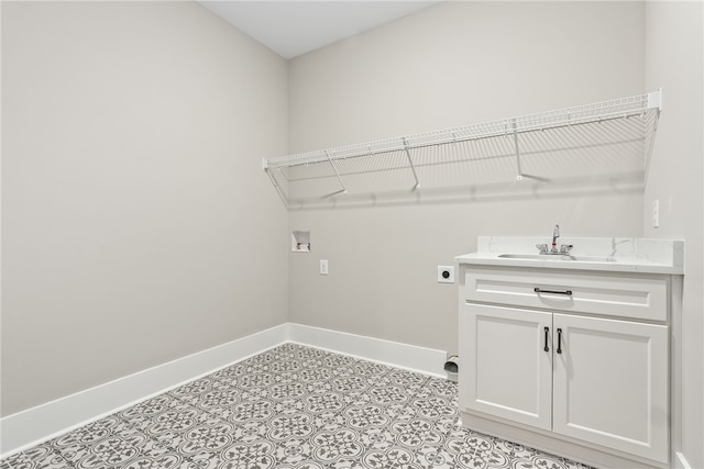 laundry room with hookup for a washing machine, cabinet space, hookup for an electric dryer, a sink, and baseboards