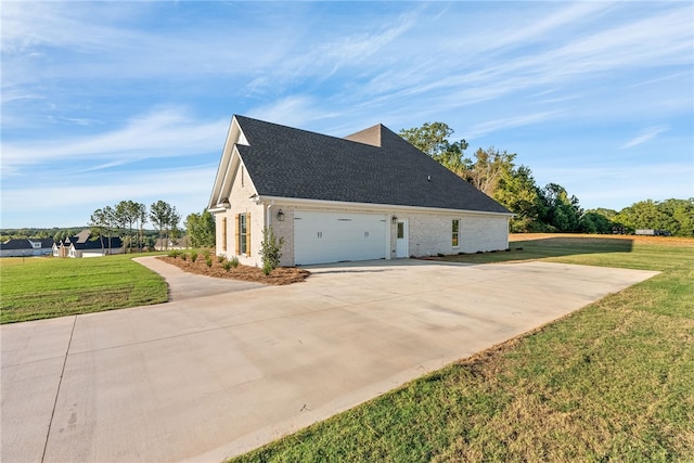 view of side of property featuring brick siding, a shingled roof, a lawn, a garage, and driveway