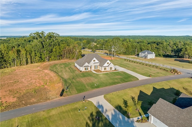 birds eye view of property with a wooded view