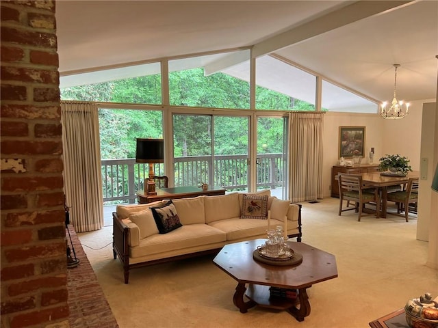 living room featuring light colored carpet, vaulted ceiling, and an inviting chandelier