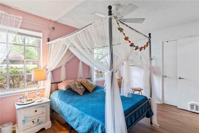 bedroom with a ceiling fan and wood finished floors