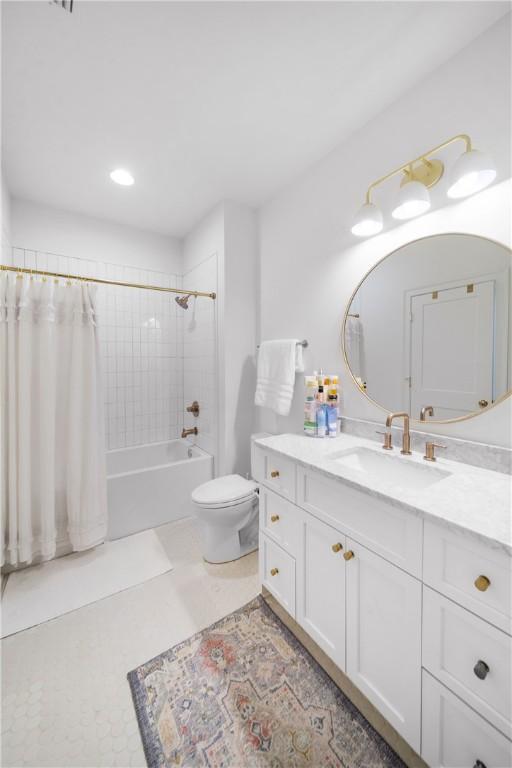 bathroom featuring washtub / shower combination, tile patterned flooring, vanity, and toilet