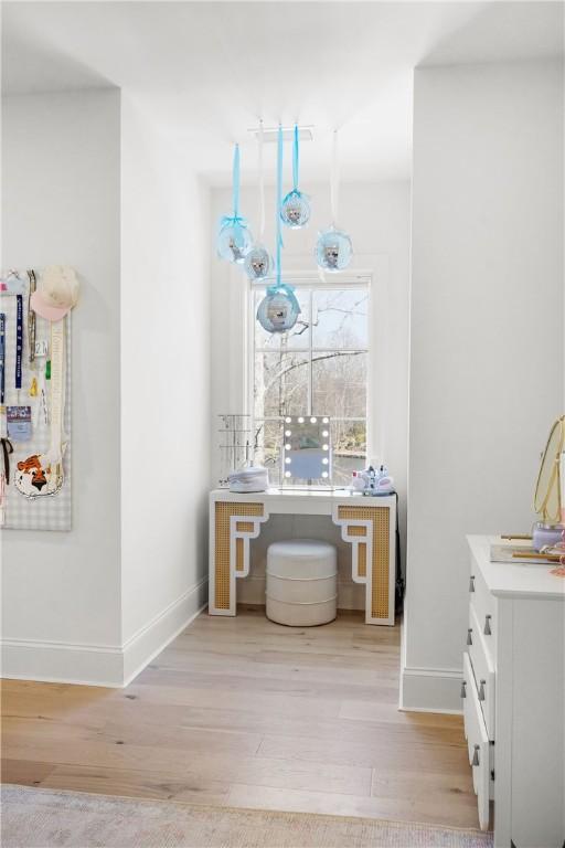 bathroom featuring vanity, baseboards, and wood finished floors