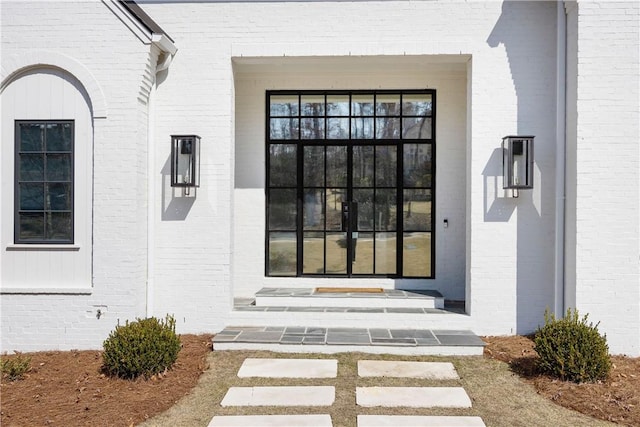 property entrance featuring brick siding