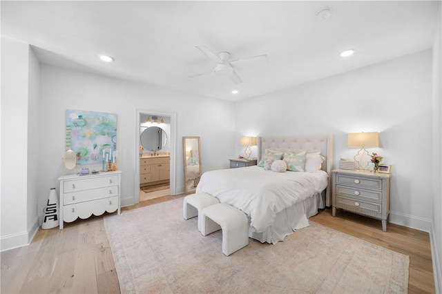 bedroom with connected bathroom, baseboards, wood finished floors, and recessed lighting